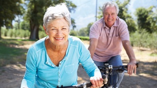 Elderly couple riding bikes